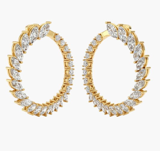 Gold hoop earrings with clear gemstones on a white background