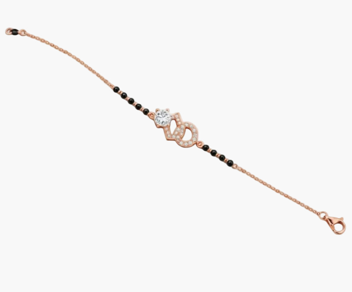 Rose gold bracelet with black beads on a white background