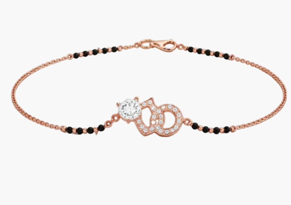 Rose gold bracelet with black beads and a decorative clasp on a white background
