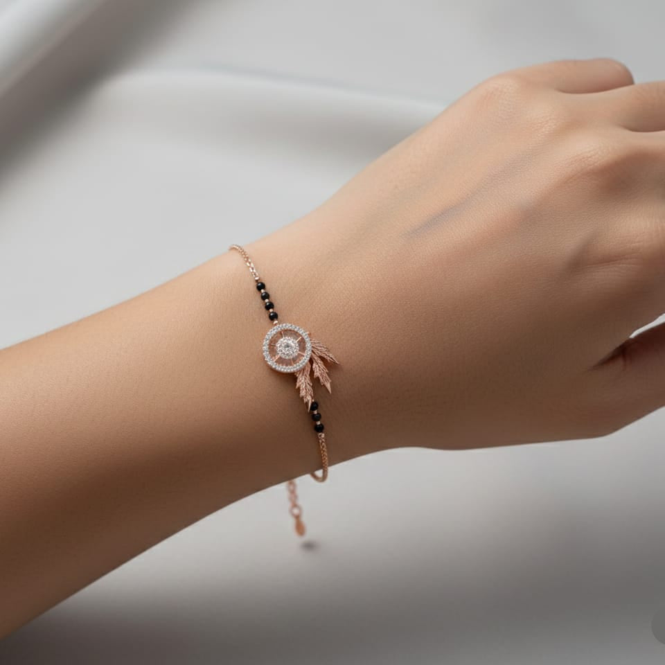 Hand wearing a delicate bracelet with a blurred background