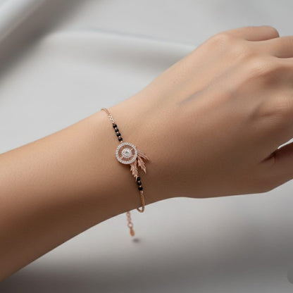 Hand wearing a delicate bracelet with a blurred background
