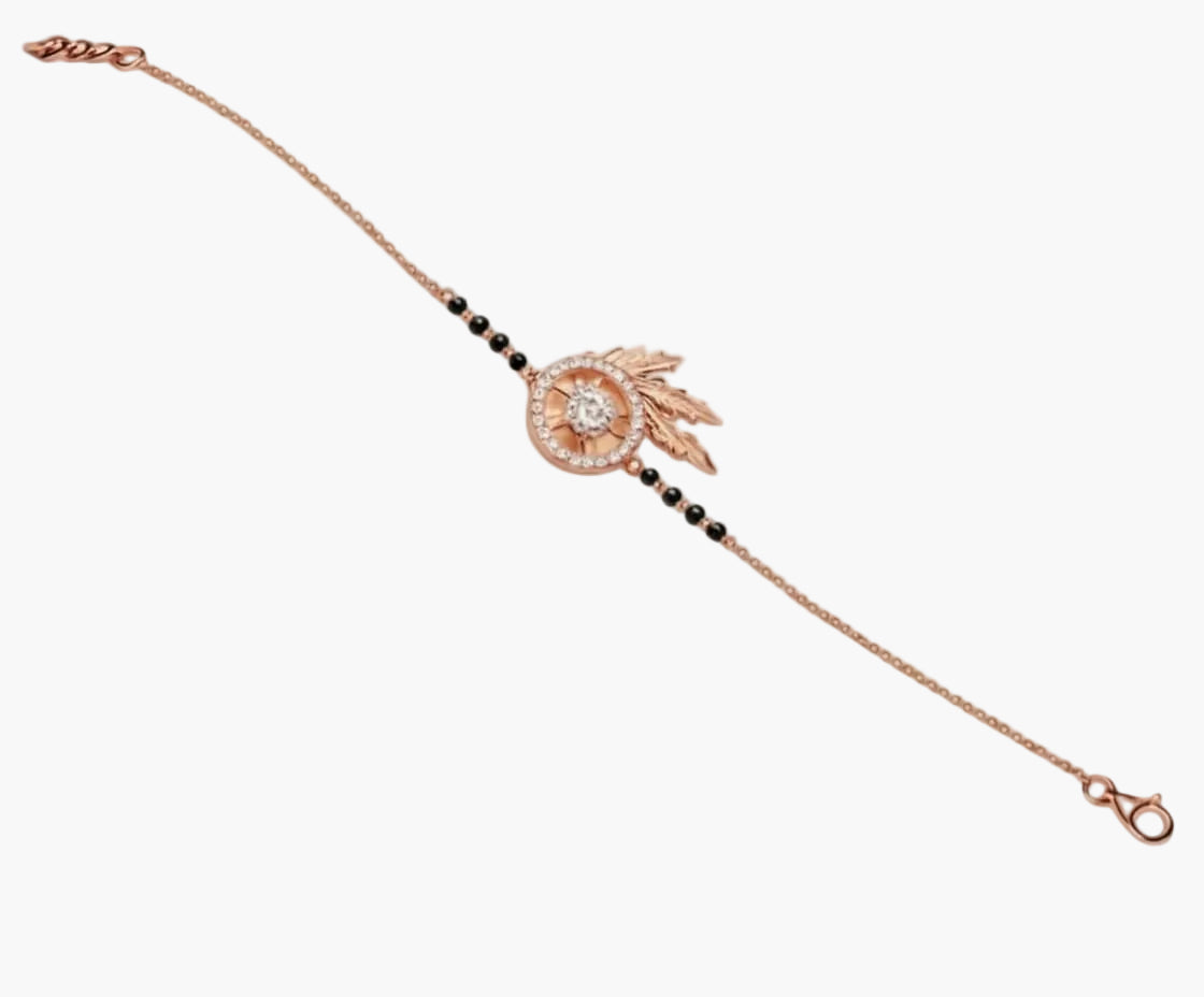 Rose gold bracelet with black beads on a white background