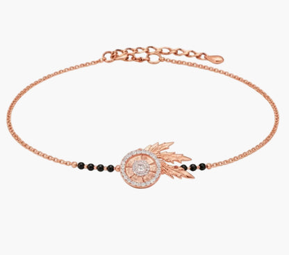 Rose gold bracelet with black beads on a white background
