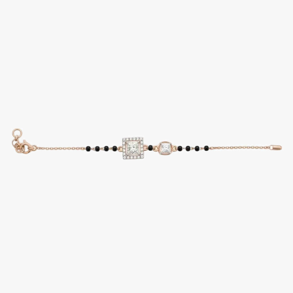 Bracelet with black beads and rose gold clasp on a white background