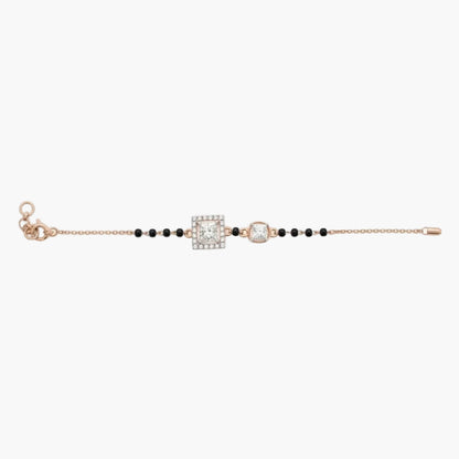 Bracelet with black beads and rose gold clasp on a white background