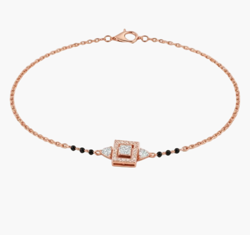 Rose gold bracelet with black beads and a square clasp on a white background