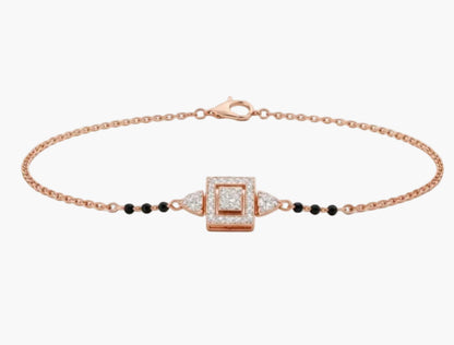 Rose gold bracelet with diamond and black bead details on a white background