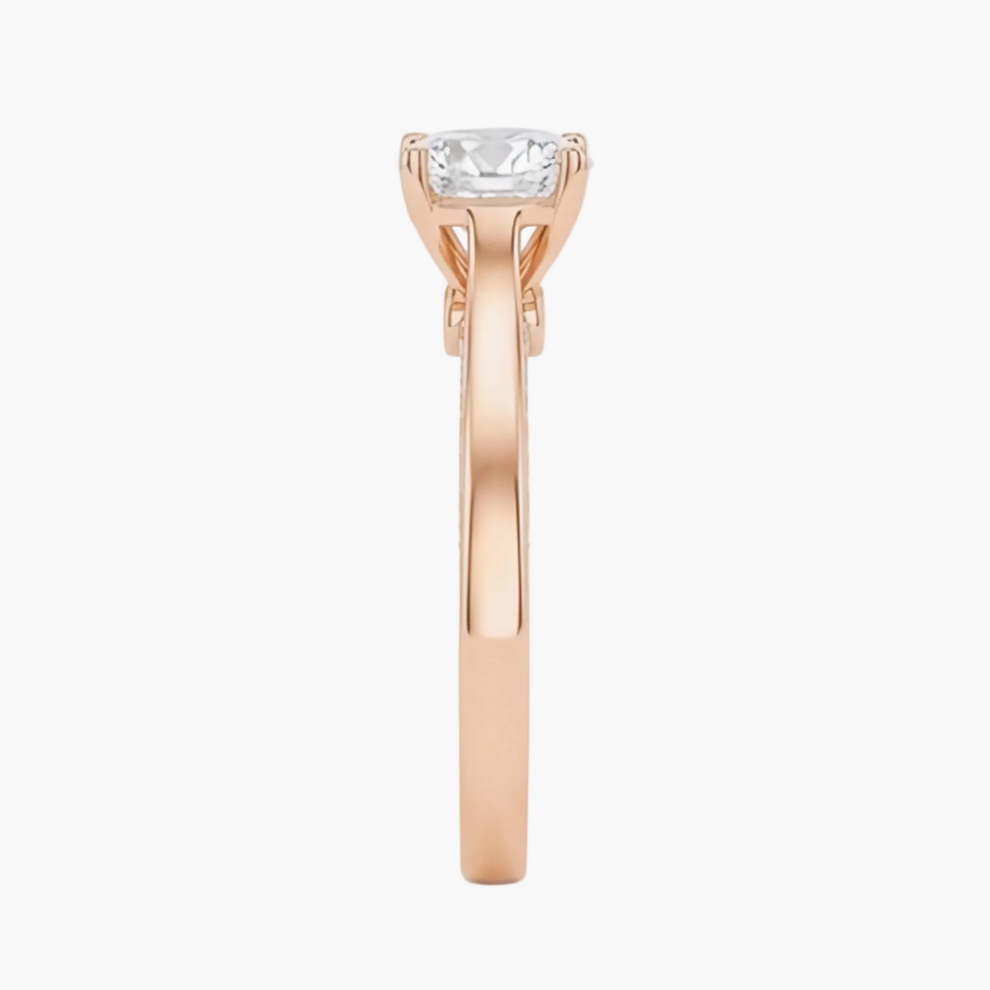 Rose gold ring with a diamond on a white background