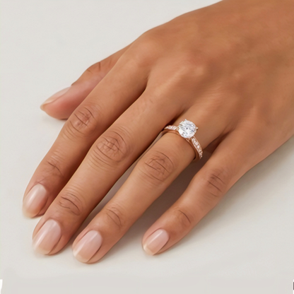 Hand wearing a diamond ring on a light background