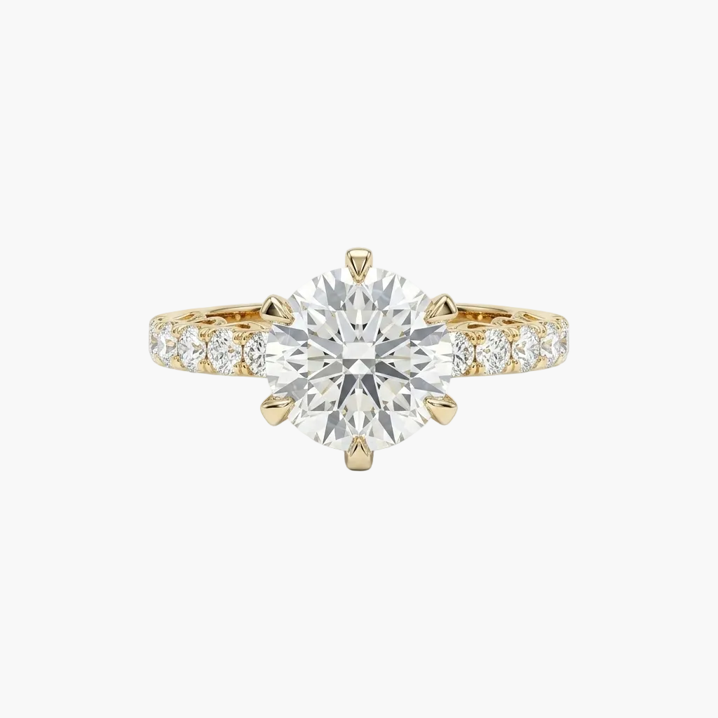 Gold ring with a large diamond and smaller diamonds on the band against a white background