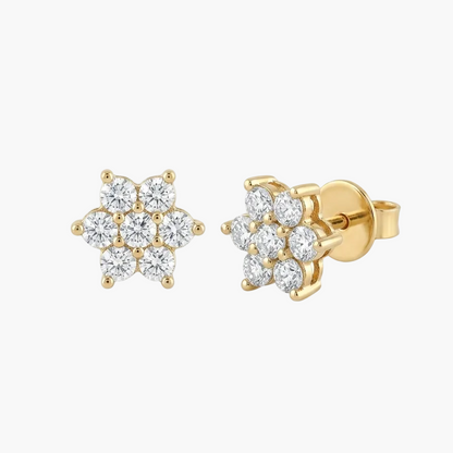 Gold flower-shaped earrings with clear gemstones on a white background