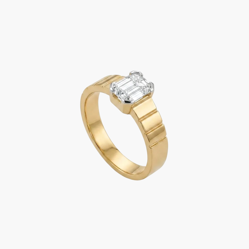 Gold ring with a diamond on a white background