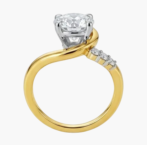 Gold ring with a large diamond and smaller diamonds on the band against a white background