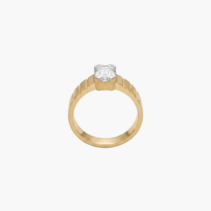 Gold ring with a diamond on a light gray background