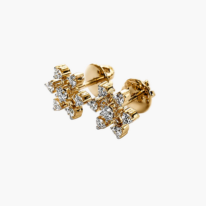 Gold earrings with diamond-like stones on a white background