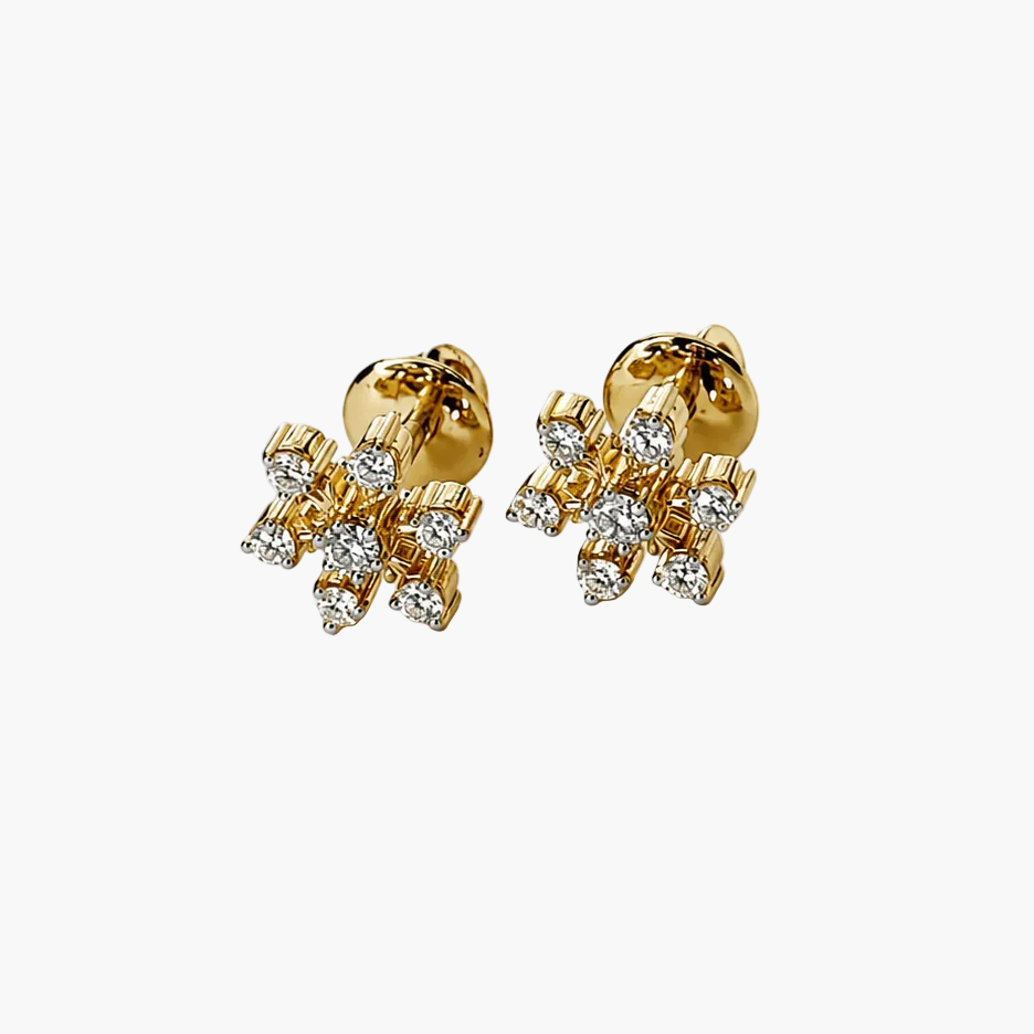 Gold earrings with diamond accents on a white background