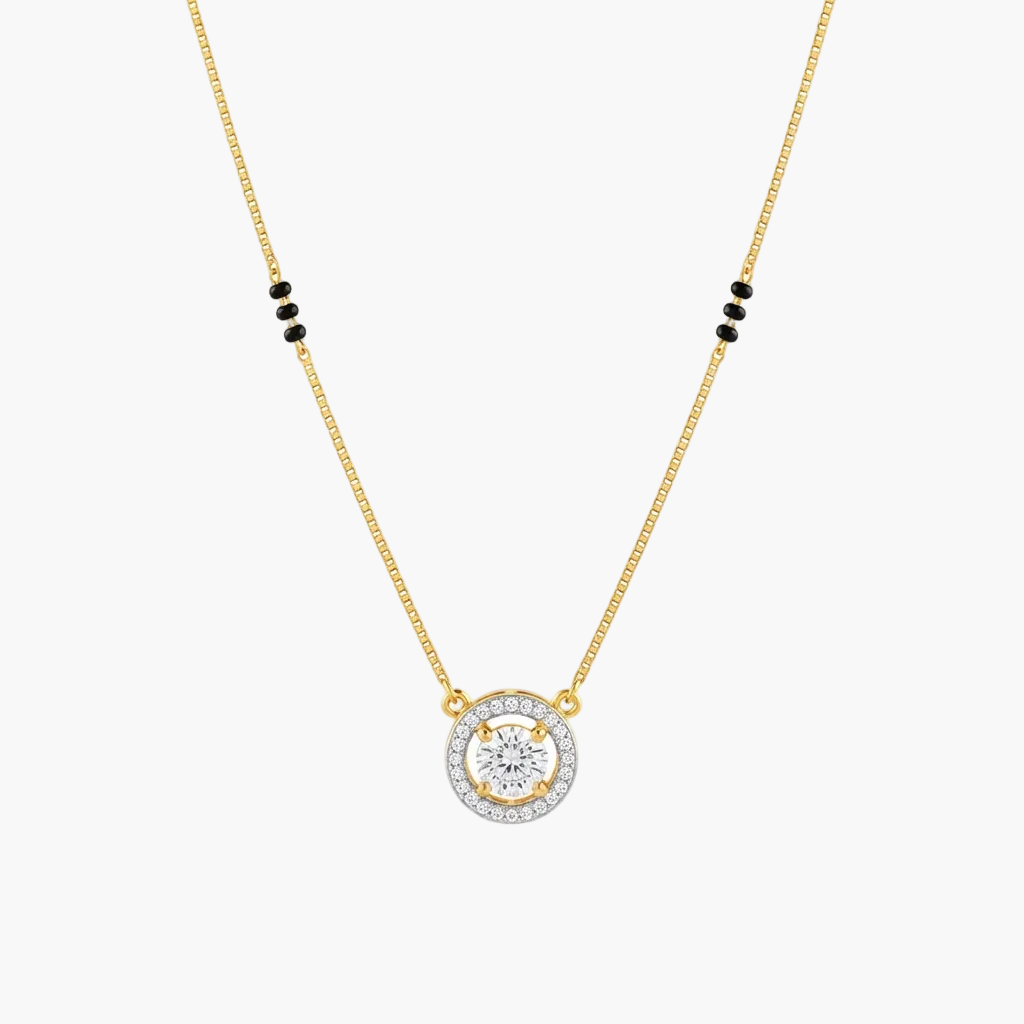 A gold chain necklace with a circular pendant featuring a central clear gemstone surrounded by a halo of small clear stones, with small black bead accents on the chain, shown on a plain white background.