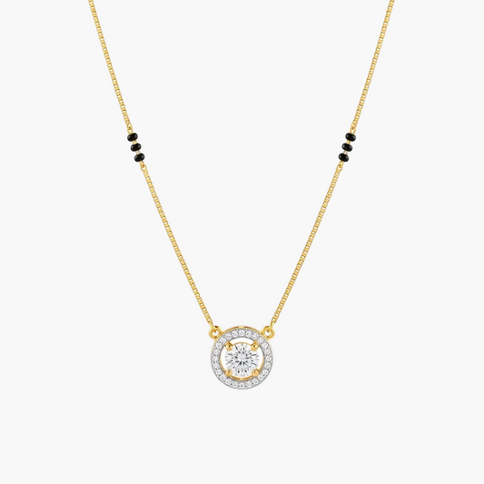 A gold chain necklace with a circular pendant featuring a central clear gemstone surrounded by a halo of small clear stones, with small black bead accents on the chain, shown on a plain white background.