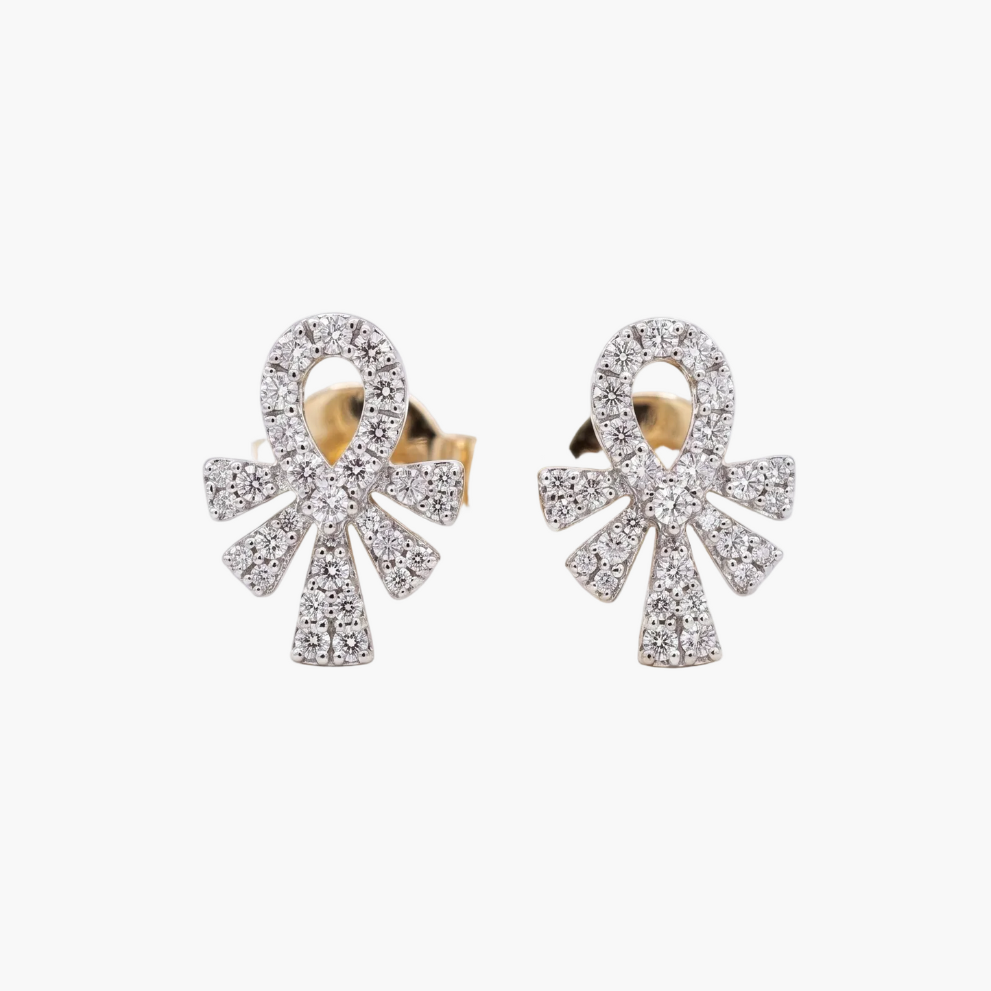 Pair of bow-shaped earrings with gemstones on a white background