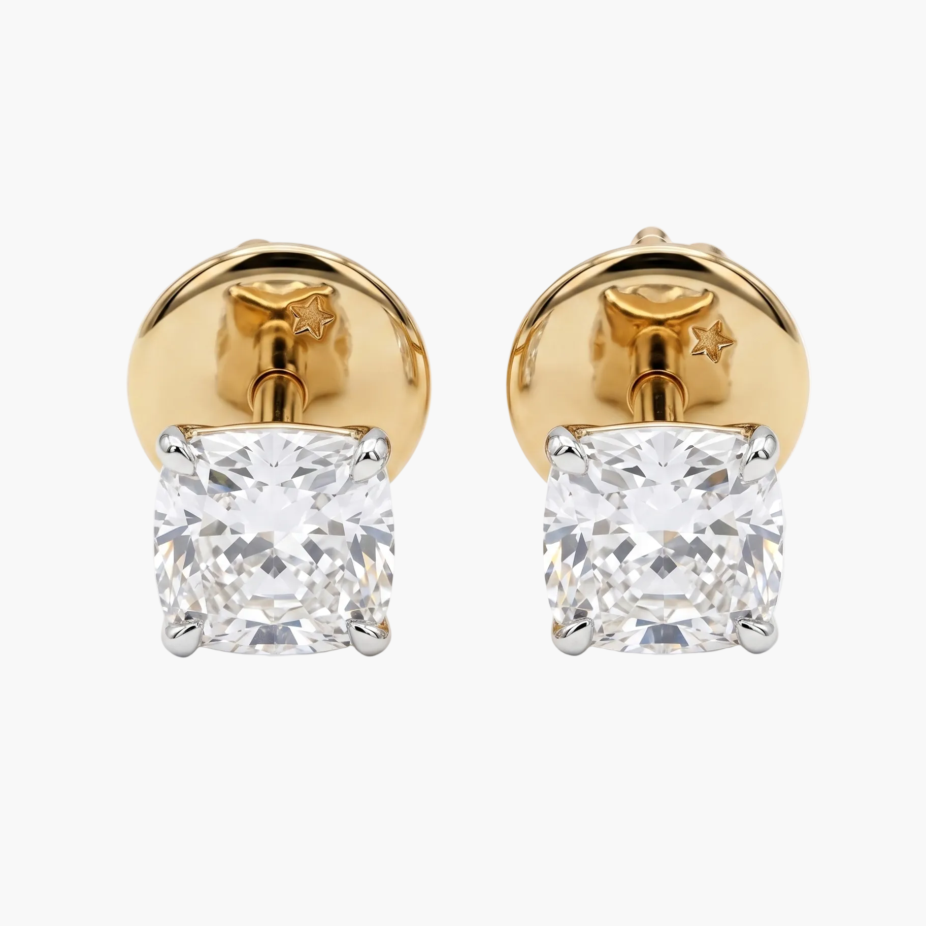 Gold earrings with clear gemstones on a white background