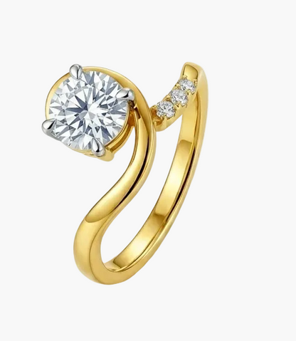 Yellow gold ring with a large diamond and smaller diamonds on the band against a white background.