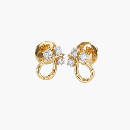 Gold earrings with diamond accents on a light gray background