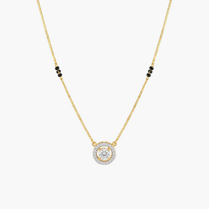 A delicate gold chain necklace featuring a circular pendant with a central clear gemstone surrounded by a halo of small clear stones, accented by three small black beads on each side of the chain, shown on a plain white background.