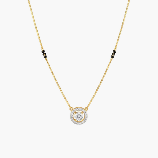 A delicate gold chain necklace featuring a circular pendant with a central clear gemstone surrounded by a halo of small clear stones, accented by three small black beads on each side of the chain, shown on a plain white background.