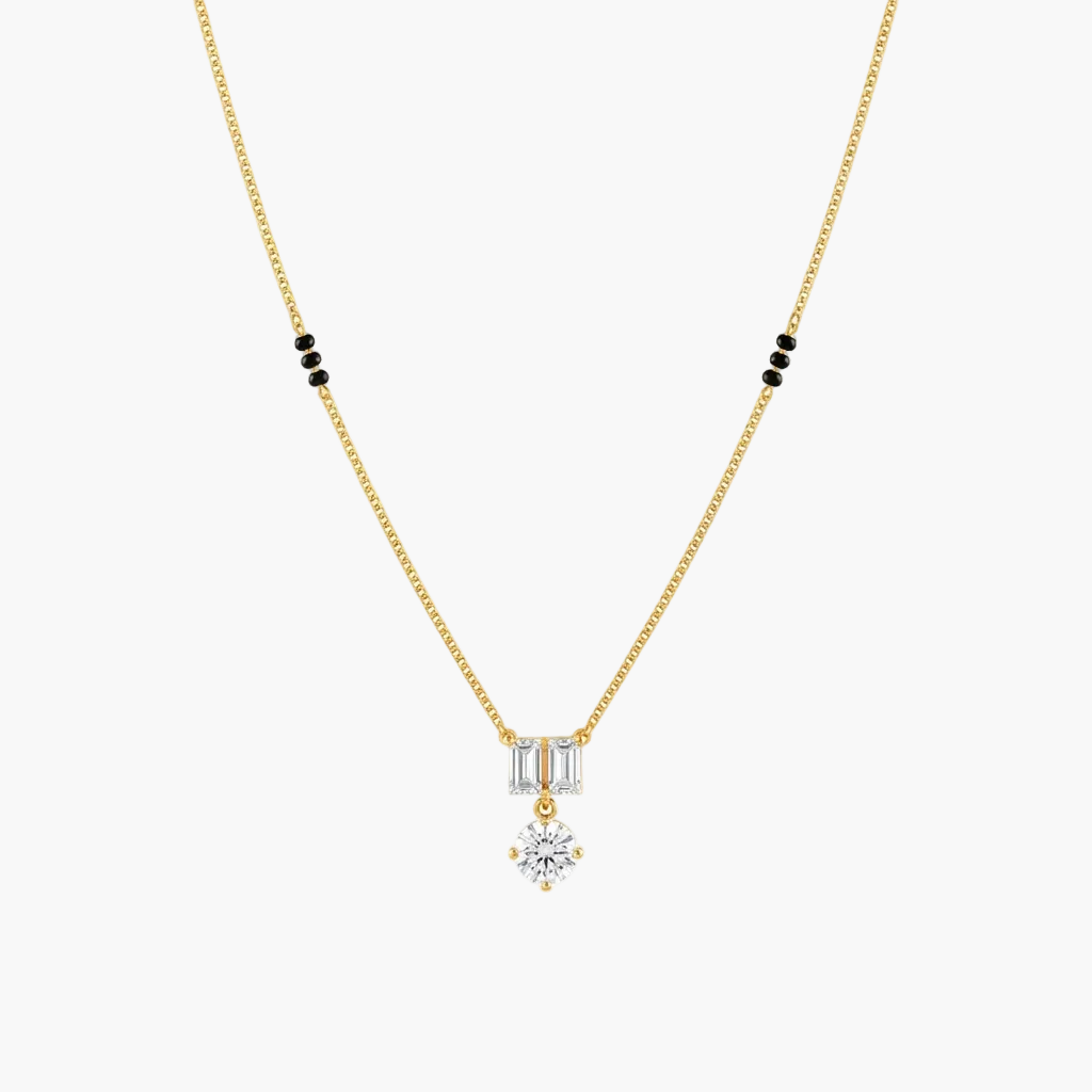 A delicate yellow gold chain necklace featuring a pendant with baguette-cut clear stones and a central round-cut clear stone, accented by small black beads on the chain, shown against a plain white background.