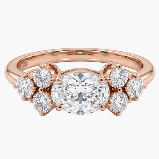 Rose gold ring with a large diamond and smaller diamonds on a white background