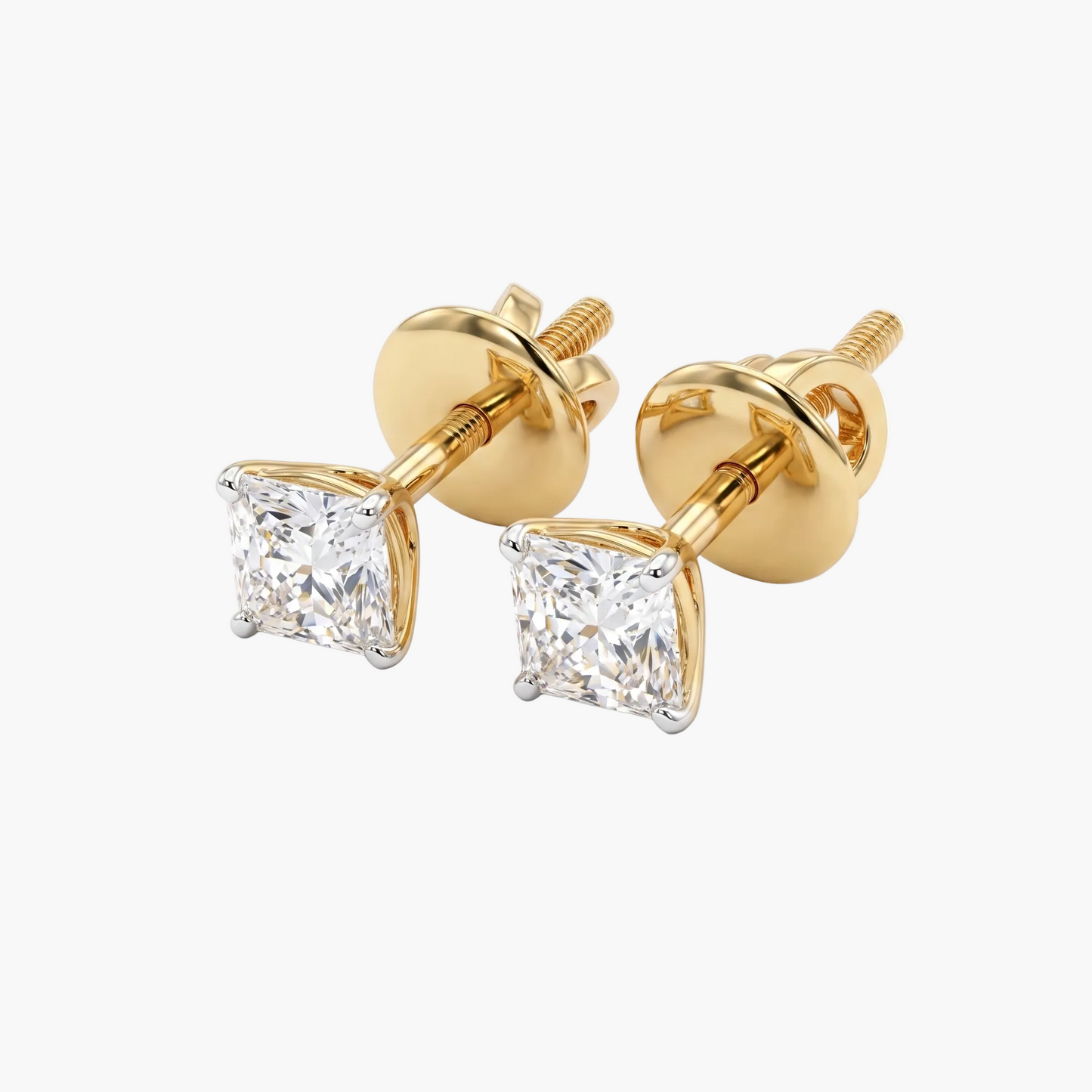 Gold earrings with clear gemstones on a white background