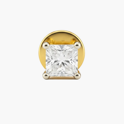 Gold earring with a clear gemstone on a white background