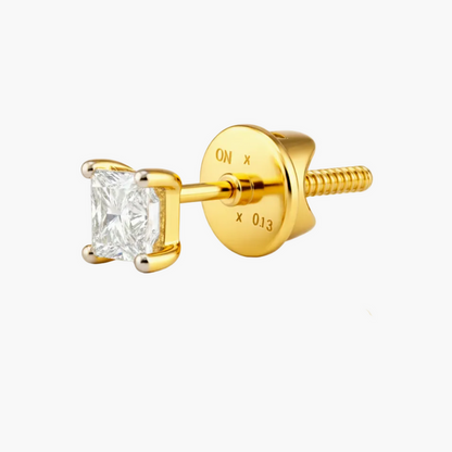 Gold earring with a clear gemstone on a white background