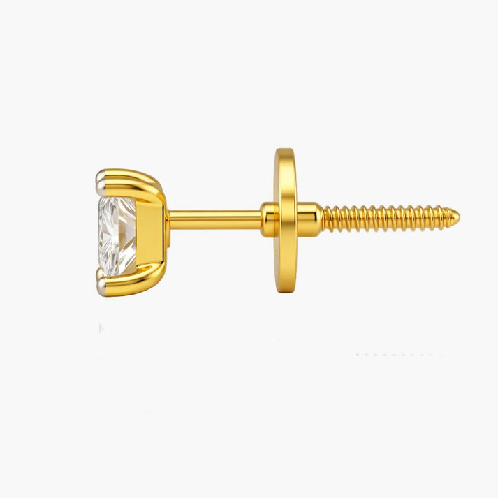 Gold earring with a clear gemstone on a white background