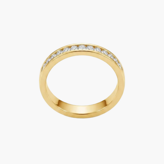 A yellow gold eternity ring featuring a row of small clear pavé-set stones along the top half of the band, shown on a clean white background.
