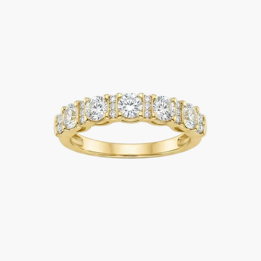 A yellow gold eternity ring featuring a row of round-cut clear gemstones, presented on a clean white background.