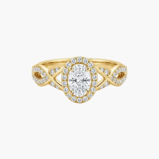 A yellow gold halo ring featuring an oval-cut center stone surrounded by a halo of small round stones, with a split shank accented by pavé-set diamonds on a clean white background.