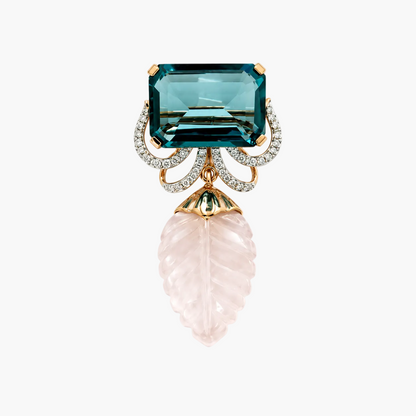 A luxury gold and rose gold pendant brooch featuring a large emerald-cut teal topaz stone, a carved pale pink leaf dangle, and a halo of small clear pavé diamonds, shown on a solid white background.