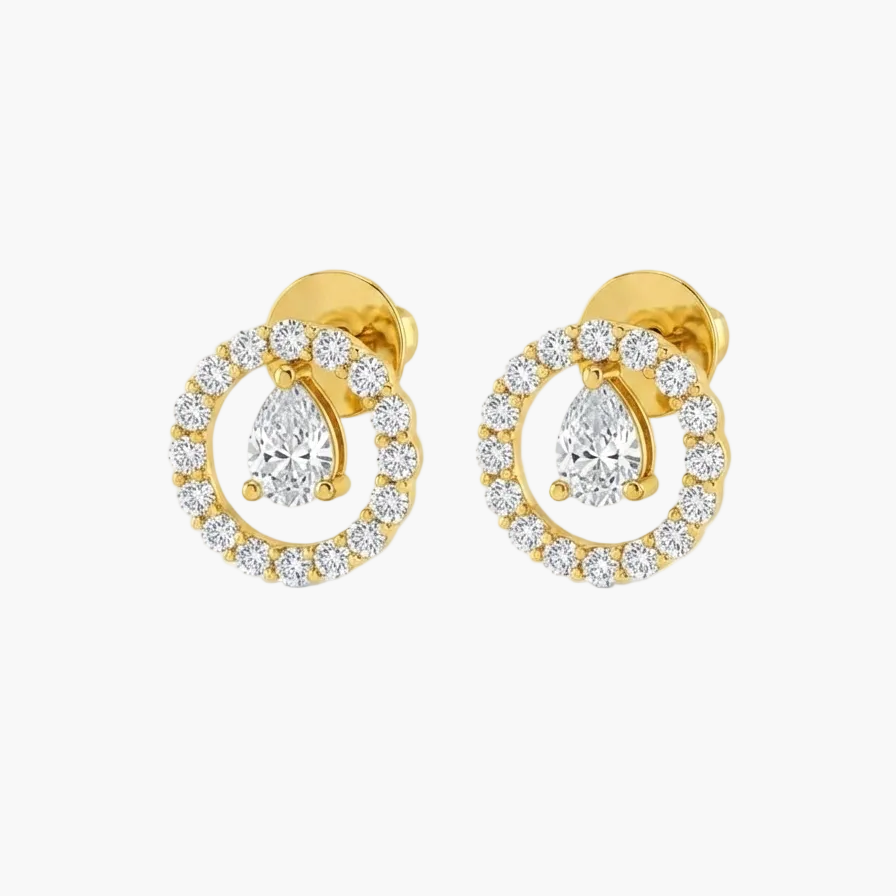 A pair of gold stud earrings featuring pear-cut center stones surrounded by a halo of small clear stones, shown on a plain white background.