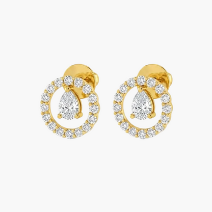 A pair of gold stud earrings featuring pear-cut center stones surrounded by a halo of small clear stones, shown on a plain white background.
