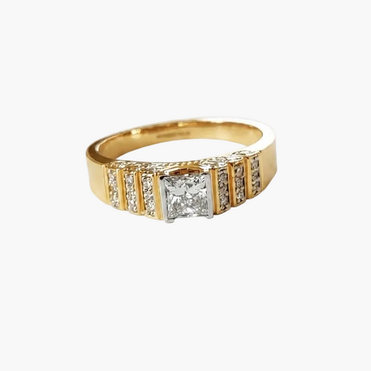 A yellow gold ring featuring a central princess-cut diamond flanked by channel-set round diamonds, shown on a plain white background.