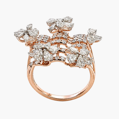 A rose gold ring featuring a large, intricate floral cluster pavé set with numerous clear round diamonds, photographed on a clean white background.