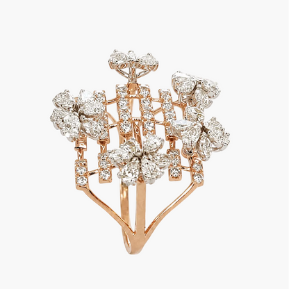 A rose gold ring featuring a floral cluster design set with numerous clear round-cut diamonds, photographed against a solid white background.