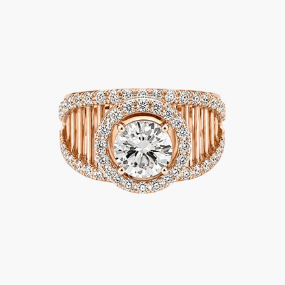 A rose gold ring featuring a large round-cut center stone surrounded by a halo of small pavé stones, with a wide band composed of vertical channel settings and a curved pavé outer edge, shown on a plain white background.