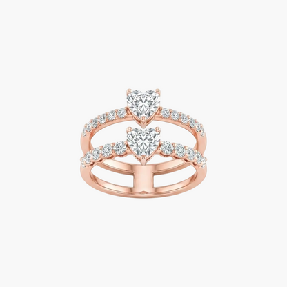 Rose gold double ring set featuring heart-shaped center stones and pavé-set round diamonds, shown on a clean white background.