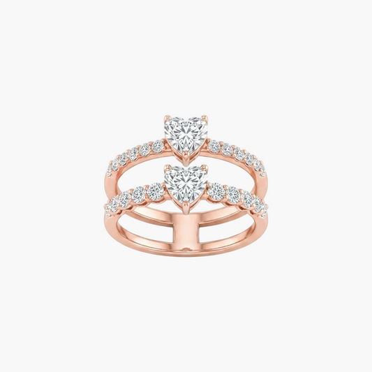 Rose gold double ring set featuring heart-shaped center stones and pavé-set round diamonds, shown on a clean white background.