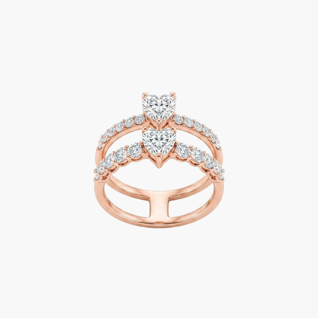 A rose gold double-band ring featuring two heart-shaped diamond center stones and rows of small round diamonds along the bands, set against a plain white background.