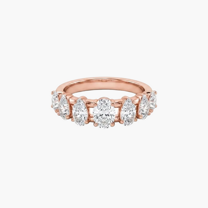 A rose gold eternity ring featuring a row of round brilliant-cut diamonds set in a polished band, shown against a plain white background.