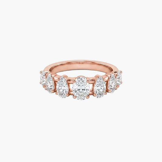 A rose gold eternity ring featuring a row of round brilliant-cut diamonds set in a polished band, shown against a plain white background.