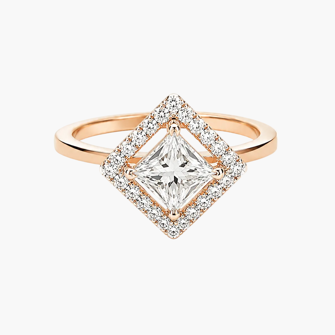 A rose gold diamond ring with a square center stone surrounded by a double halo of small clear stones, set on a plain white background.